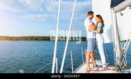 Couple On Yacht Hugging Sailing At Seaside, Enjoying Vacation, Vertical Stock Photo
