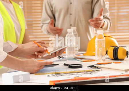 Team of constructors working at table in office, closeup Stock Photo