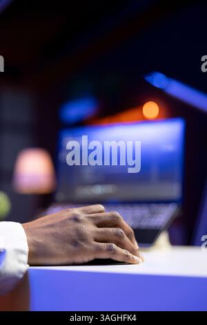 Teleworker in living room office using laptop to do coding for software developing. Remote employee typing on notebook device keyboard, solving tasks in apartment, close up Stock Photo