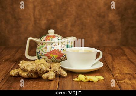 Ginger root infusion served in a teacup to combat the cold as a natural antibiotic Stock Photo