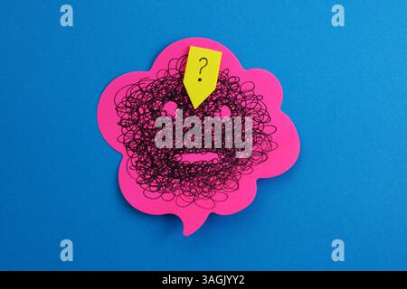 Speech bubble with question mark and face formed with conflicting message Stock Photo