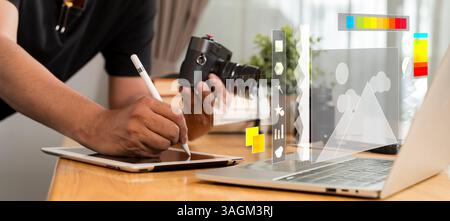 Freelancer retoucher man works on convertible laptop computer with photo editing software using stylus. Photographer or designer digital artist image Stock Photo