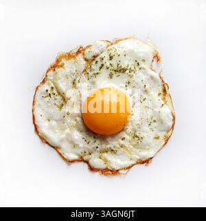 A single fried egg isolated on a white background. Healthy food concept. Directly above. Stock Photo