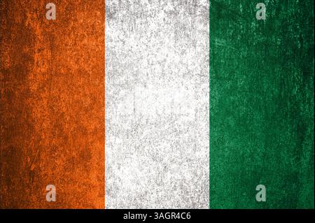 Cote d'Ivoire State Flag. Dirty Cote d'Ivoire flag on metal surface. Metal texture Stock Photo