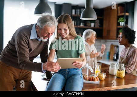 Portrait of happy multigeneration, multiethnic family having fun in kitchen at home Stock Photo