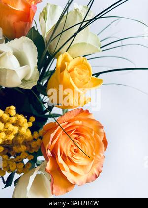 Beautiful bouquet with roses and mimosas isolated on white background.  Valentine's Day, birthday, mother's day, anniversary. Fresh flowers. Flat lay. Stock Photo