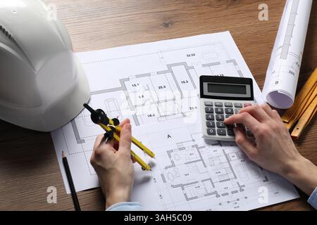 Architect working with project, closeup. Different technical drawings and construction tools on wooden table Stock Photo