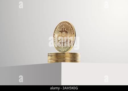 Golden Bitcoins stacked on top of a white table on a gray background. Stock Photo