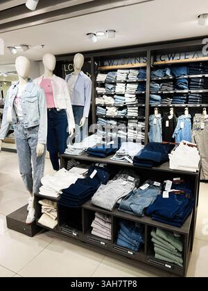 Mannequins in stylish T-shirts and jeans in the clothing department of ...