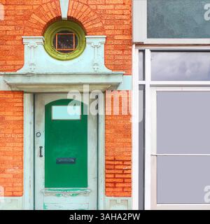 Green door set in an ornate limestone frame beneath a circular window with a green trim, contrasting against vibrant orange brick in a Chicago streets. Stock Photo