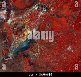 Dec. 12, 2014 - This image from Japanâ€™s ALOS satellite was captured over part of southern Borneo, an island in Southeast Asia..Politically, the island is divided between Brunei, Malaysia and Indonesia. The area pictured covers part of South Kalimantan province in Indonesiaâ€™s territory, with the city of Amuntai in the upper-central section of the image. The network of white lines show manmade constructions such as houses lined up along rivers and roads. Dark blue shows swamps. False-colour images in infrared provide detailed information on vegetation, such as plant type and health. This inf Stock Photo