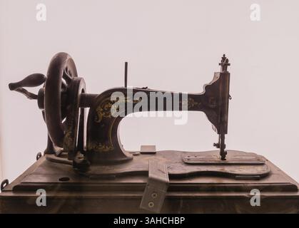 Seoul, South Korea, January, 19, 2018: Antique Singer sewing machine with detailed gold leaf design on display behind glass.with white background, Asi Stock Photo