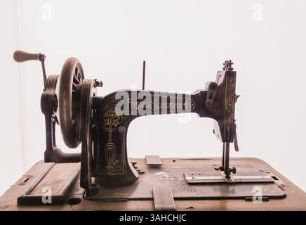 Seoul, South Korea, January, 19, 2018: Antique Frister and Rossmann sewing machine with detailed gold leaf design on display behind glass.with white b Stock Photo