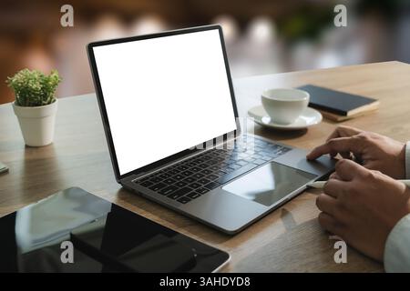 mock up Using laptop with blank screen computer modern young man using computer at workplace Stock Photo