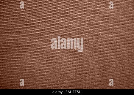 Photo of textured fabric. Mocha Mousse. Different shadows of brown color. The texture of fabrics consists of small dots. Intertwined threads. Material Stock Photo