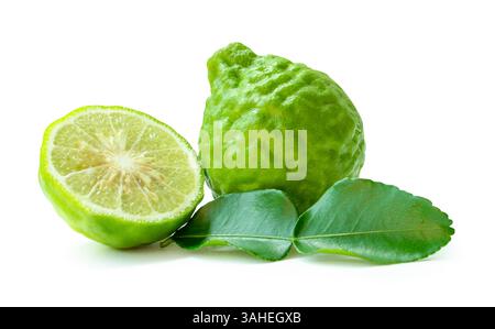 Side view of fresh green bergamot fruits or kaffir lime with half and green leaf in stack is isolated on white background with clipping path. Stock Photo