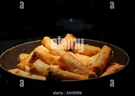deep fried spring rolls  surve on the pan in dark background Stock Photo