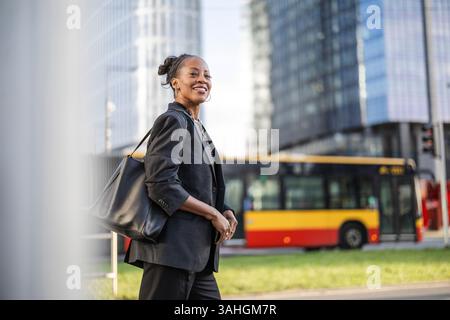 Happy business woman using public transport in the city Stock Photo
