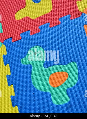 Colorful blue yellow red soft carpet squares puzzle mat for kids with animals Stock Photo