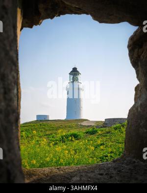 Lighthouse with a frame from a rock wall in Taiwan Stock Photo