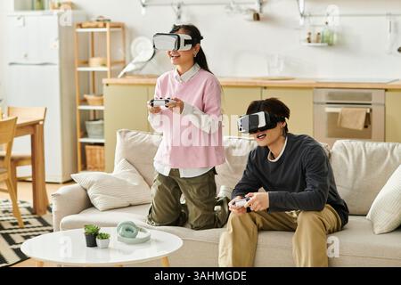 A playful couple enjoys virtual reality gaming, filled with laughter and excitement. Stock Photo