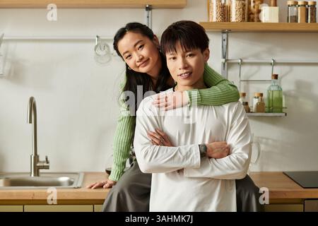 Couple enjoys a cozy breakfast in their kitchen, sharing love and laughter. Stock Photo