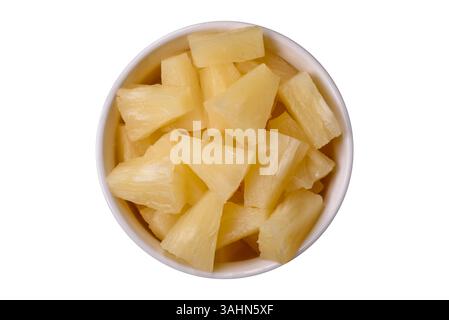 Tropical sweet tinned pineapple fruit sliced into slices. Pineapple as an ingredient for pizza or salad Stock Photo