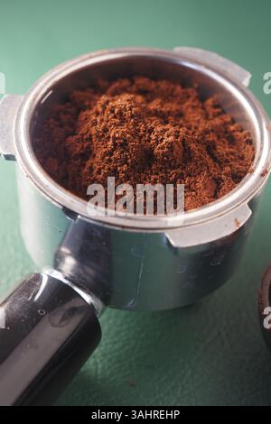 Freshly ground coffee in a portafilter ready for brewing espresso Stock Photo