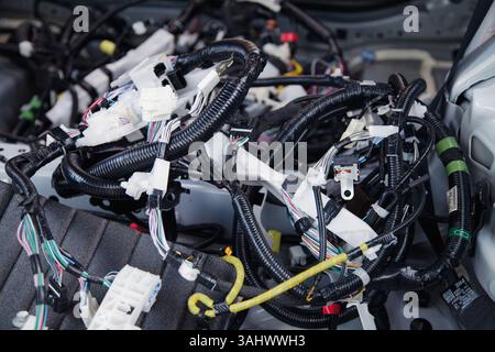 Wires, connectors, modules, and connections from a new car wiring harness to replace the old wiring in a vehicle Stock Photo