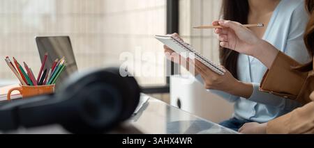 Collaboration and Study Sessions. Two students engaging in a vibrant study session as they share ideas and notes. Stock Photo