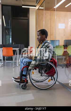 Man in wheelchair in office Stock Photo