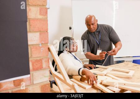 Disabled man and woman working in workshop Stock Photo
