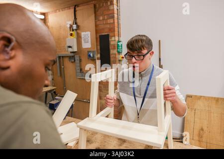 Disabled men working in workshop Stock Photo
