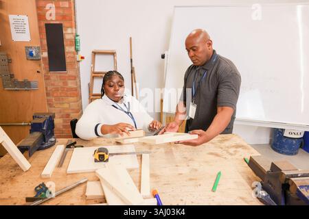 Disabled man and woman working in workshop Stock Photo