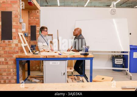 Disabled men working in workshop Stock Photo