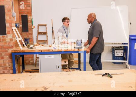 Disabled men working in workshop Stock Photo