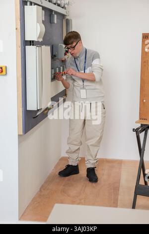 Man with Down Syndrome working in workshop Stock Photo