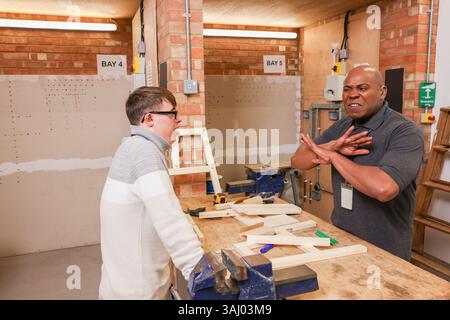 Disabled men working in workshop Stock Photo
