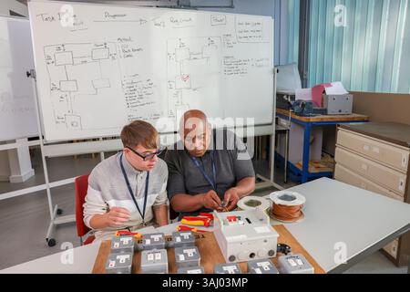 Disabled men working in workshop Stock Photo