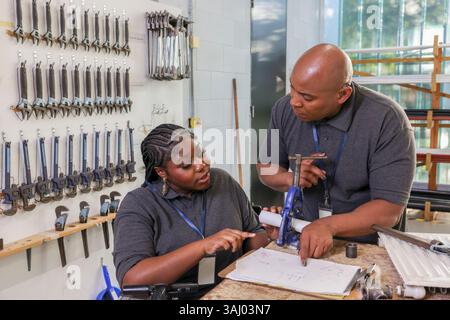 Disabled man and woman working in workshop Stock Photo