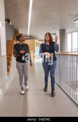 Coworkers using sign language in office Stock Photo
