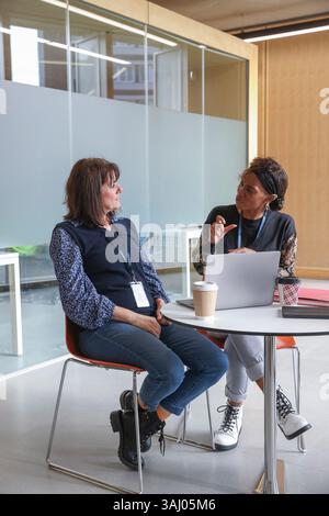 Coworkers using sign language in office Stock Photo