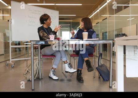 Coworkers using sign language in office Stock Photo