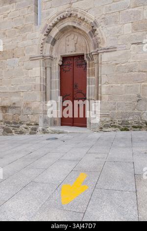 October 17, 2015 - Sarria, Galicia/Province of Lugo, Spain - Galicia, Spain: Typical yellow arrow marking the Camino FrancÃ©s on the RÃºa Maior near the Iglesia San Salvador. Many pilgrims choose Sarria as the starting point to the Camino de Santiago. The distance from this point to Santiago allows them to travel the necessary kilometers - either by foot, bicycle or horse - to get the Compostela, a certificate of completion of the pilgrimage. (Credit Image: © Paul Gordon via ZUMA Wire) Stock Photo