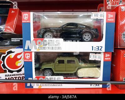 Die-cast toy car models displayed in packaging on store shelf. Stock Photo