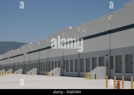 Row of loading docks at a large warehouse for shipping goods by truck. Stock Photo