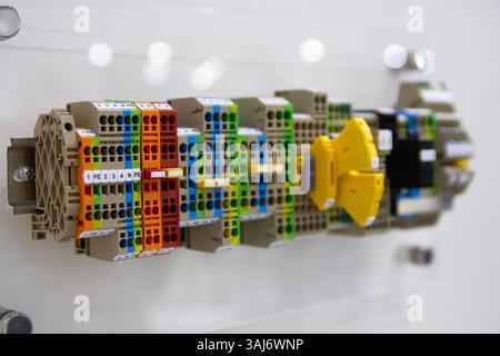 New insert terminal blocks located on a DIN rail at the exhibition stand. Industry Stock Photo