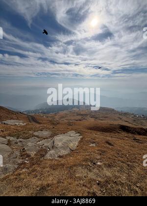 Rocky mountain Landscape Under Cloudy blue Sky and bright sun Stock Photo