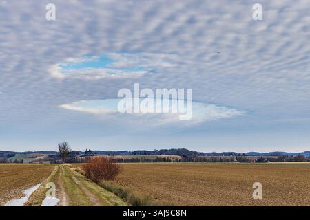 cavum, hole-punch cloud, blue hole in closed altocumulus cloud cover, Germany, Bavaria, Oberbayern, Upper Bavaria Stock Photo