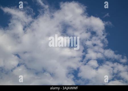 Blue sky with fluffy white clouds Stock Photo